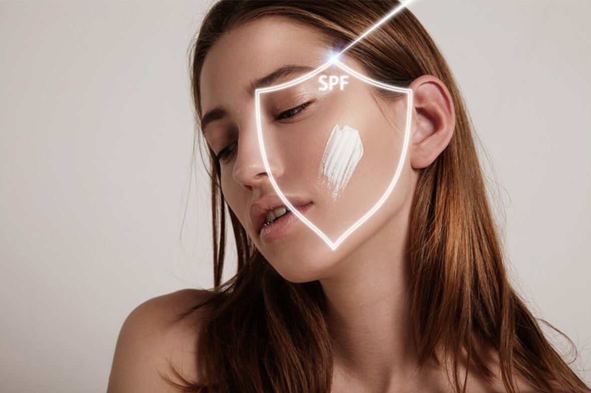 A close-up image of a woman conveys a message of improved sunscreen and skincare.